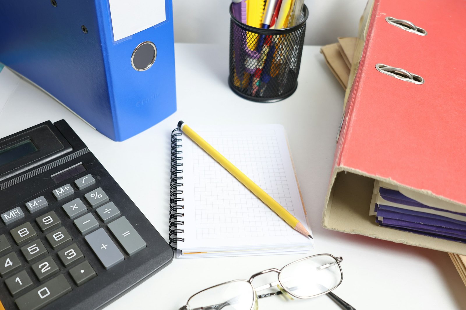 Accounting desk with calculator and binders